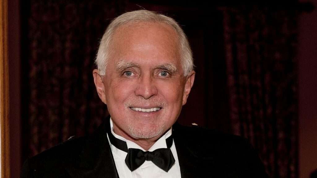 Portrait of Dan Peña in a formal black tuxedo and bowtie. This featured image represents the high-performance and discipline mindset discussed in the Caliber Motivation Co. blog post.