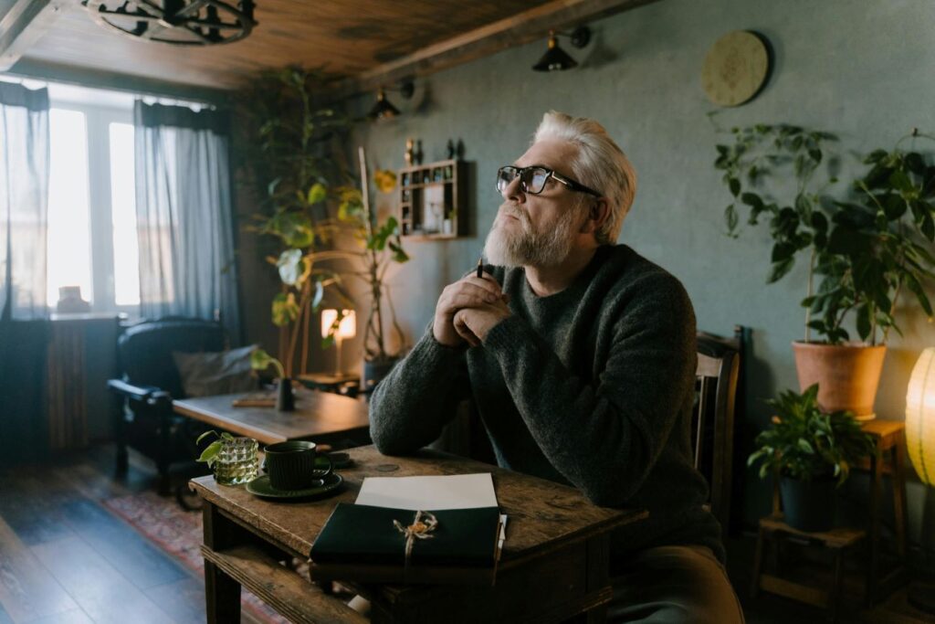 Man thinking deeply at desk improving discipline through structured thinking and self-analysis