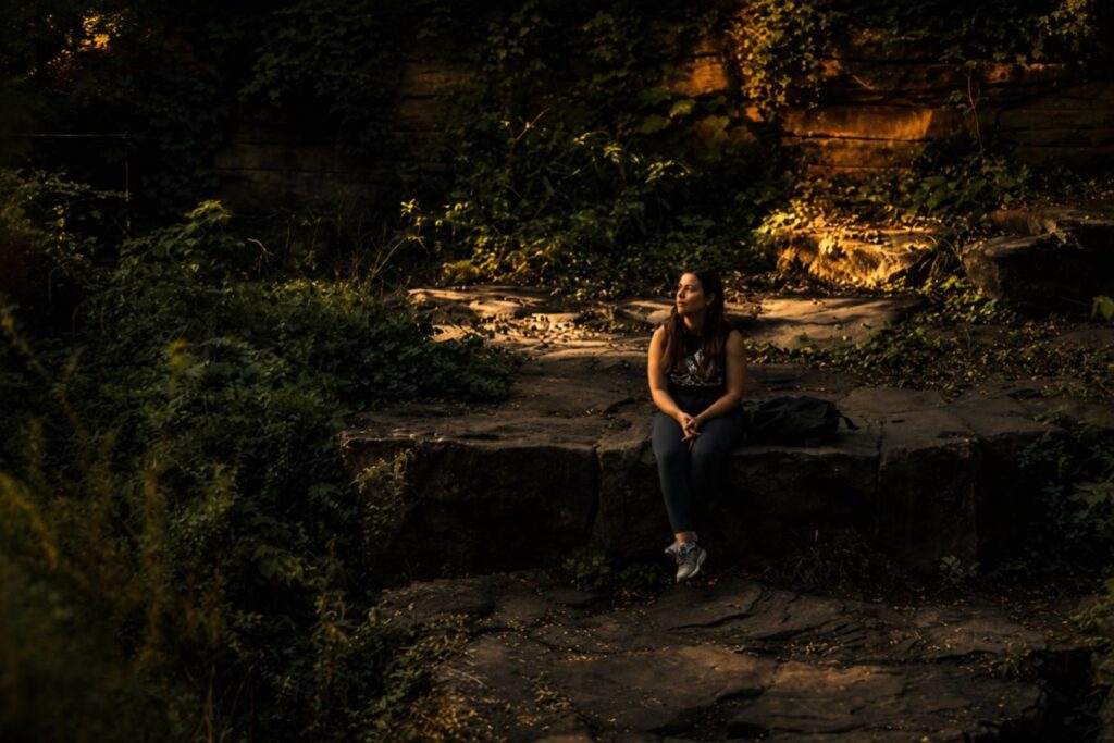 Woman sitting alone in golden light reflecting on self-discipline, self-respect, and choosing yourself daily