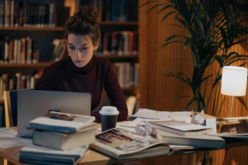 Woman working late at night learning and building skills as ruthless consistency builds freedom through long-term discipline and compounding growth