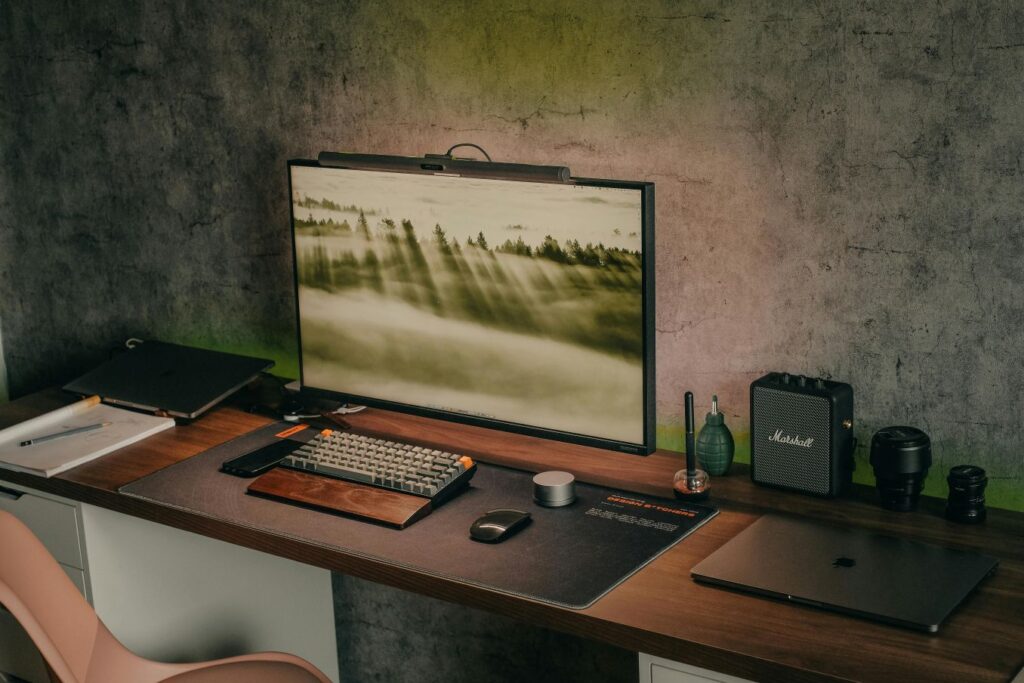 A professional workspace featuring a brown wood desk and monitor, used for a Sunday Reset Checklist for Productivity.