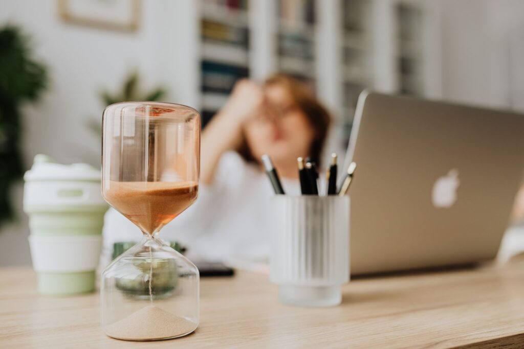 building-your-future-one-day-at-a-time Hourglass on a desk highlighting the importance of taking action today instead of waiting for tomorrow