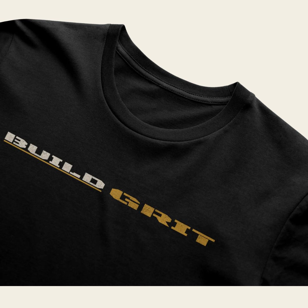 Close-up of the distressed BUILD GRIT graphic on the front of the BUILD GRIT Premium T-Shirt.