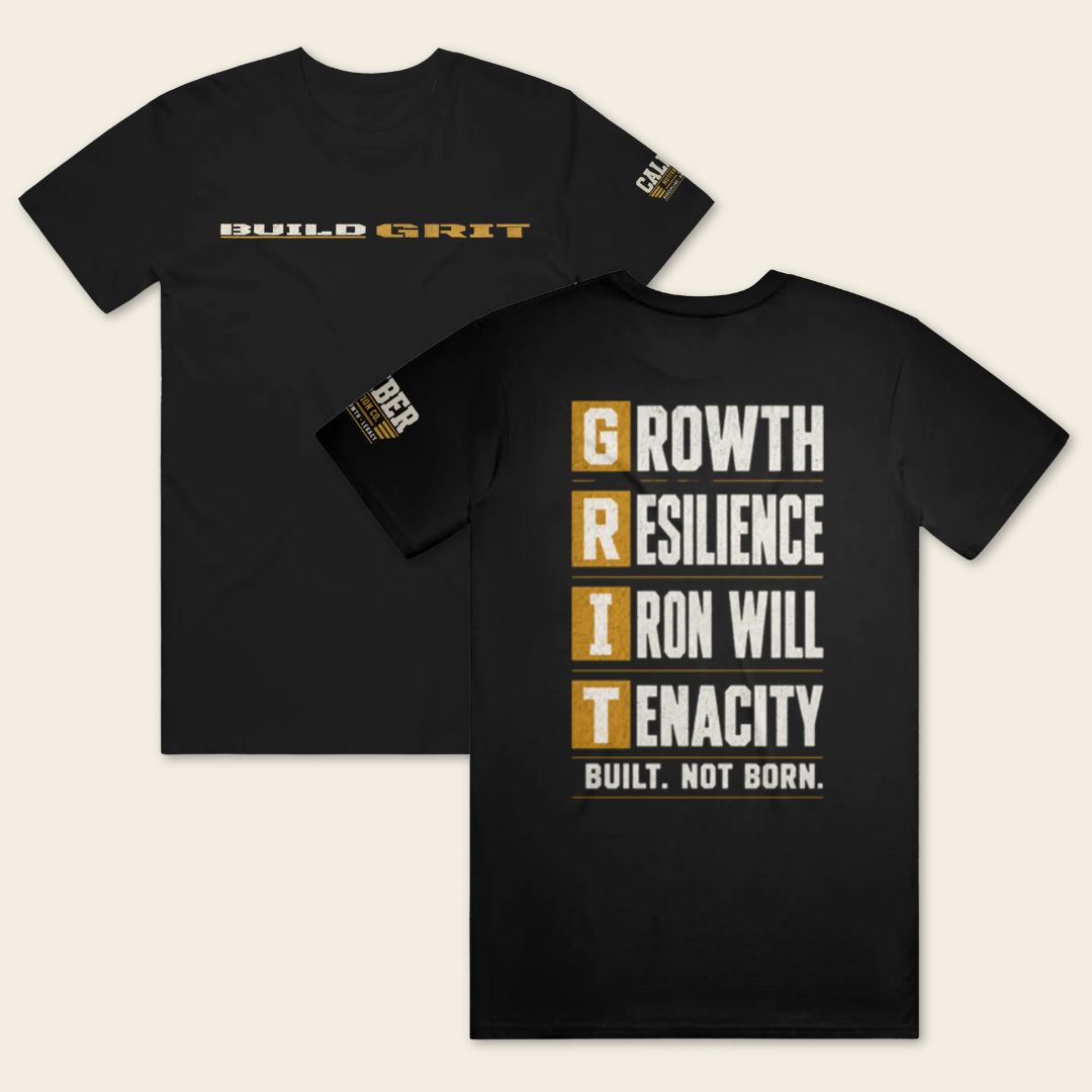 BUILD GRIT Premium T-Shirt in Graphite Black featuring distressed front and back graphics with a Caliber Motivation Co. sleeve patch.