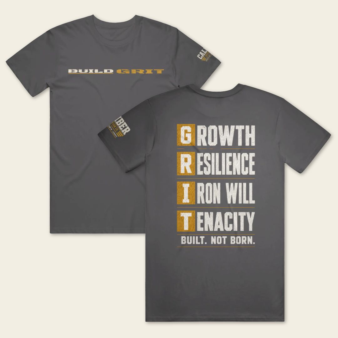 BUILD GRIT Premium T-Shirt in Heavy Metal showing front and back distressed graphics with a Caliber Motivation Co. sleeve patch.
