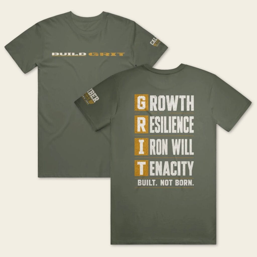 BUILD GRIT Premium T-Shirt in Military Green showing front and back views with distressed graphics and a Caliber Motivation Co. sleeve patch.