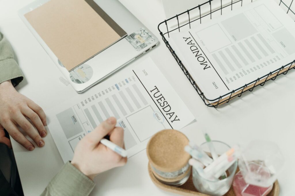 Person using a daily planner to build simple systems that protect focus and reduce mental overload.