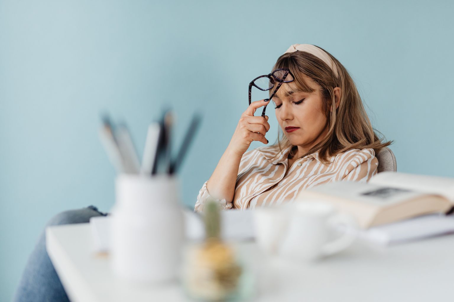 Woman feeling mentally overwhelmed while trying to focus, illustrating an overstimulated mind and mental overload.