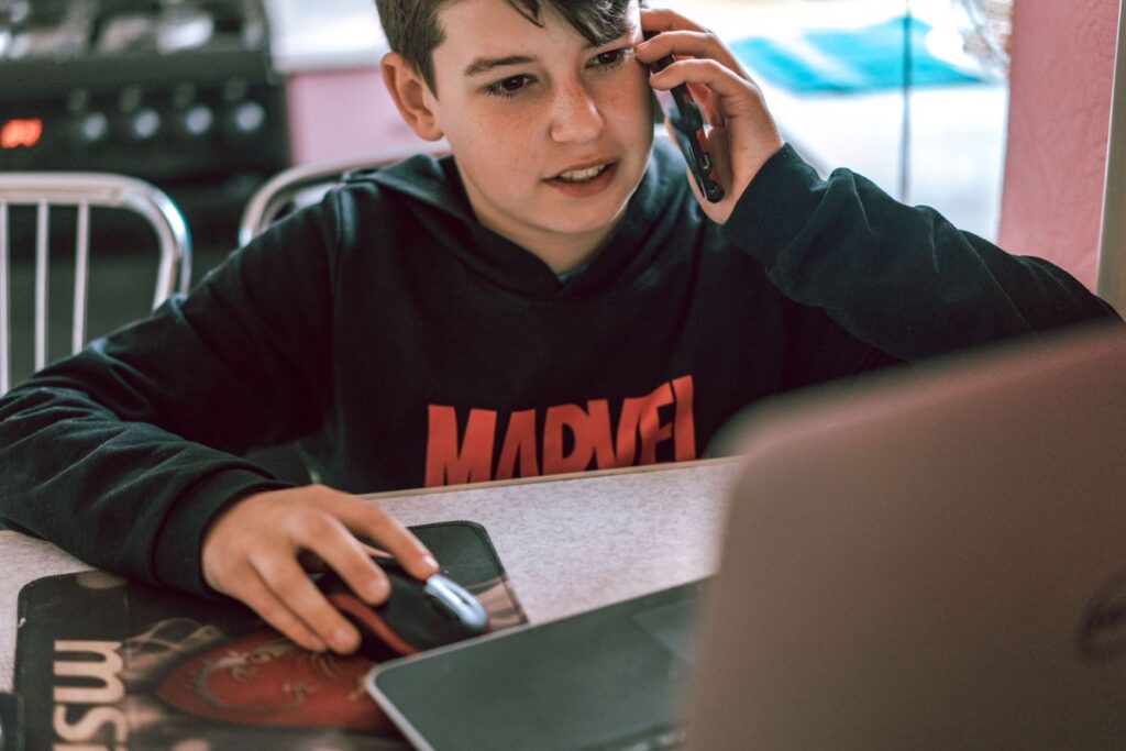 Teen using a phone to schedule a healthcare appointment and manage personal health responsibilities before adulthood.