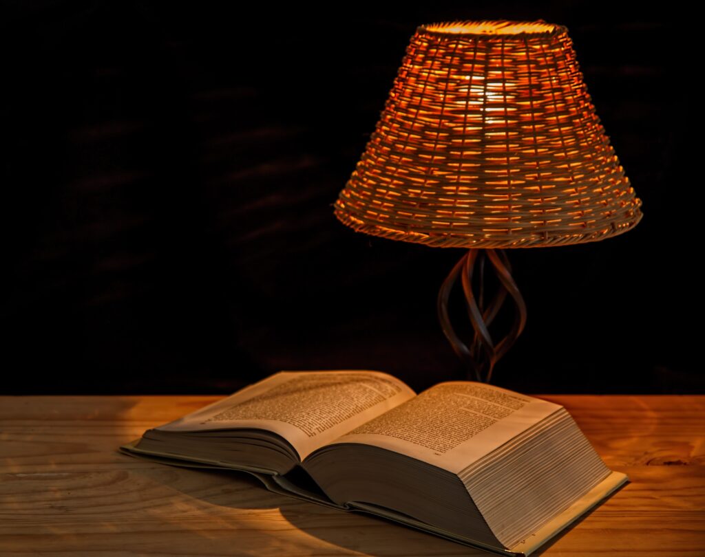 Open book under a warm lamp representing lifelong learning in Warren Buffett quotes on life and success