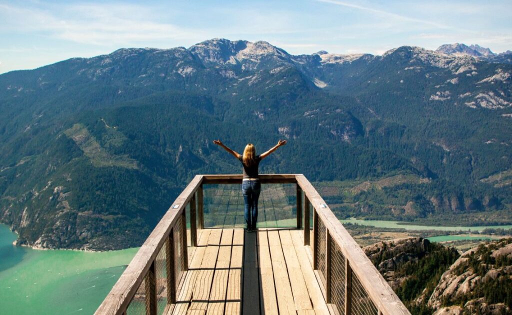 Person standing on a mountain overlook representing growth and reaching potential in David Goggins quotes