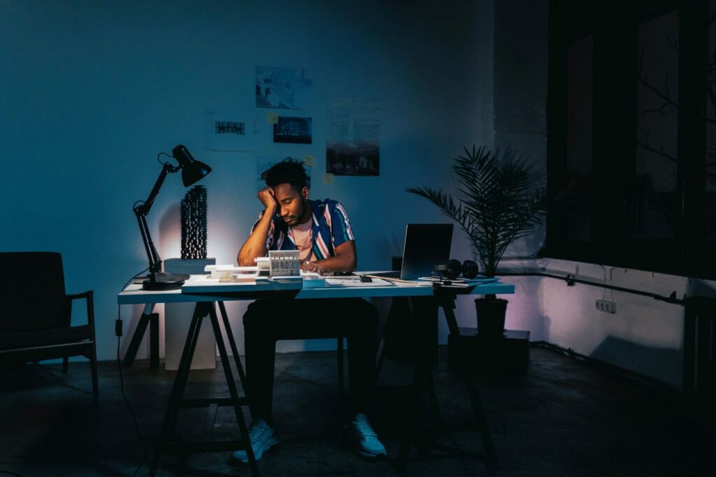 Exhausted entrepreneur working late showing the price of success and extreme focus
