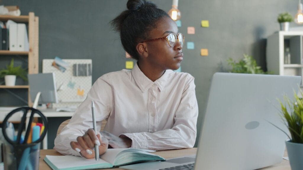 Woman working at a desk to build discipline and stay consistent on ordinary days.