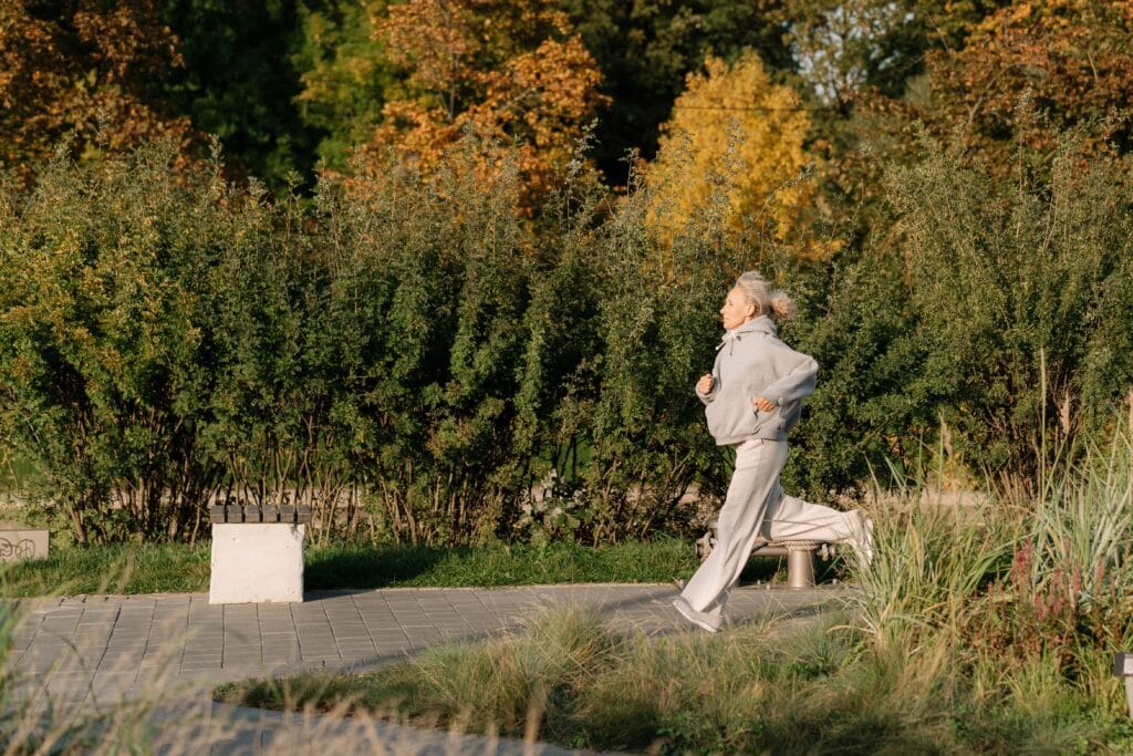 Active woman over 50 running outdoors as part of an energy protocol for women over 50