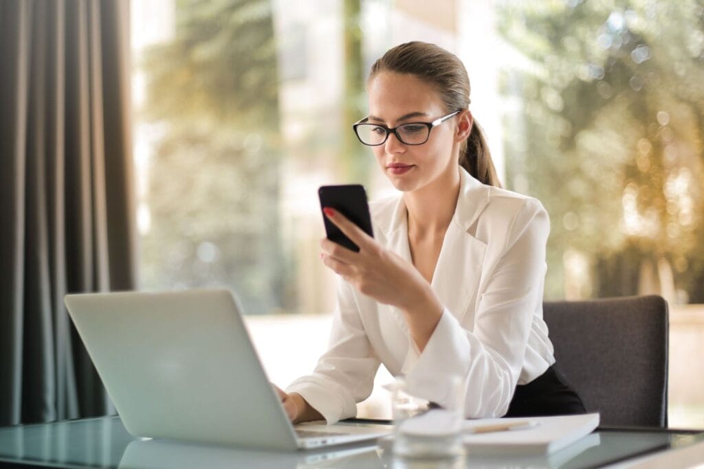 Woman using a laptop to build a productized service for recurring monthly income