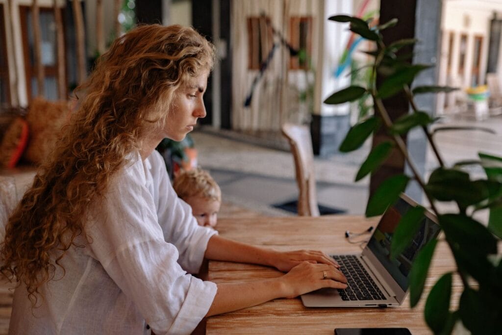 Working mother considering reasons to become an entrepreneur at her kitchen table