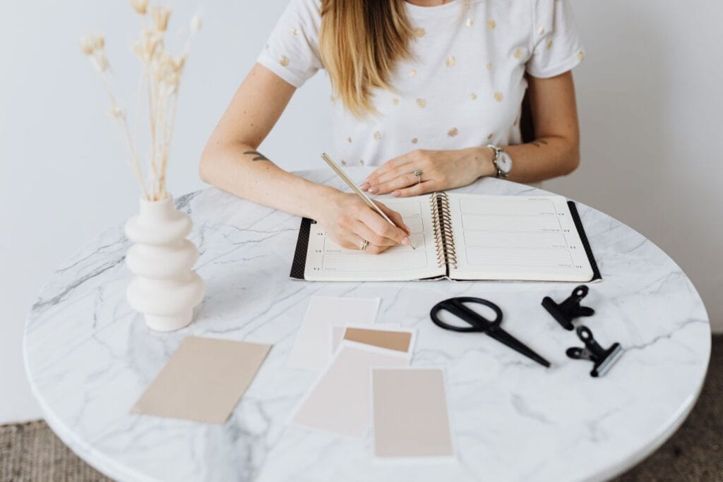 Woman planning her schedule to illustrate The Now Habit Unschedule method for balancing work and personal time