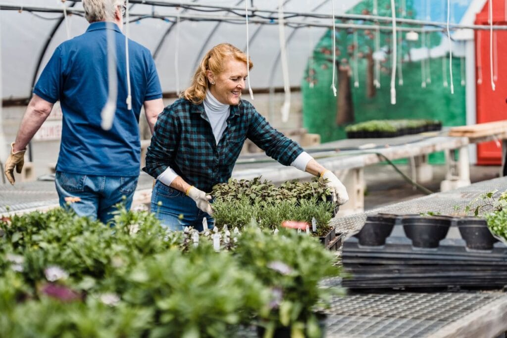 Active woman over 50 working with plants and showing energy, strength, and vitality