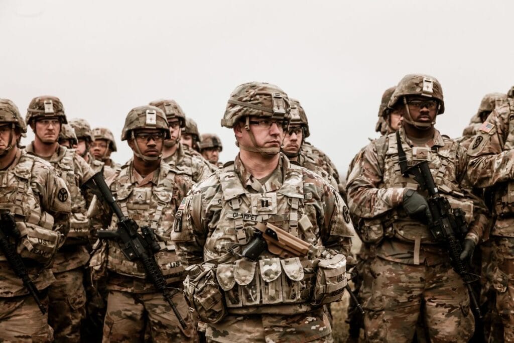 Group of U.S. Army soldiers in full combat gear, illustrating the military training discussed in the David Goggins Success Story.