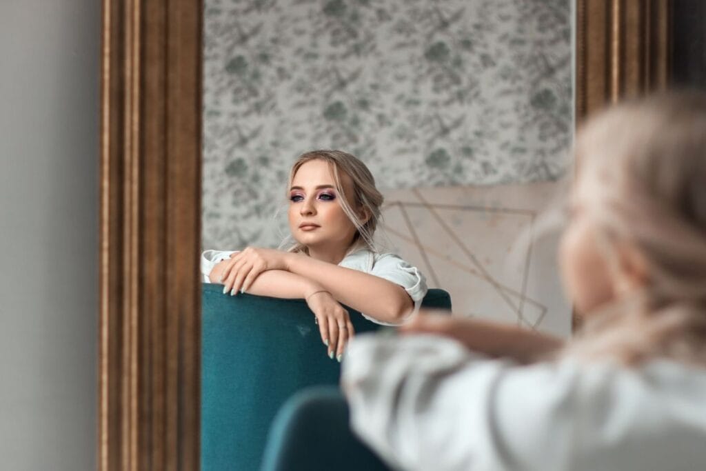 Woman reflecting in a mirror to build identity-based habits and stronger self-discipline