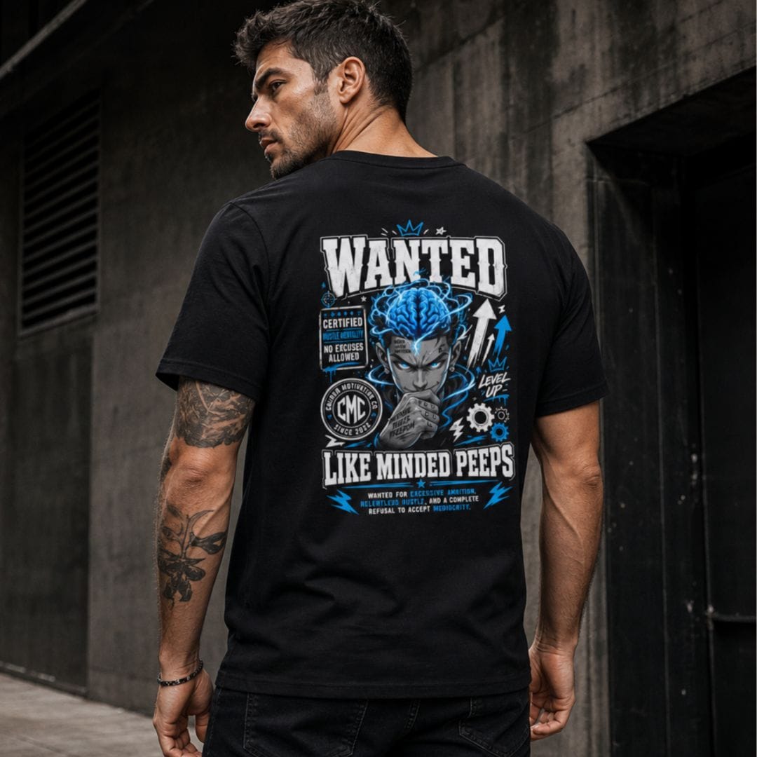 Man wearing the black Wanted Like-Minded Peeps T-Shirt, showcasing the bold electric-blue back graphic and Caliber Motivation Co. streetwear design.